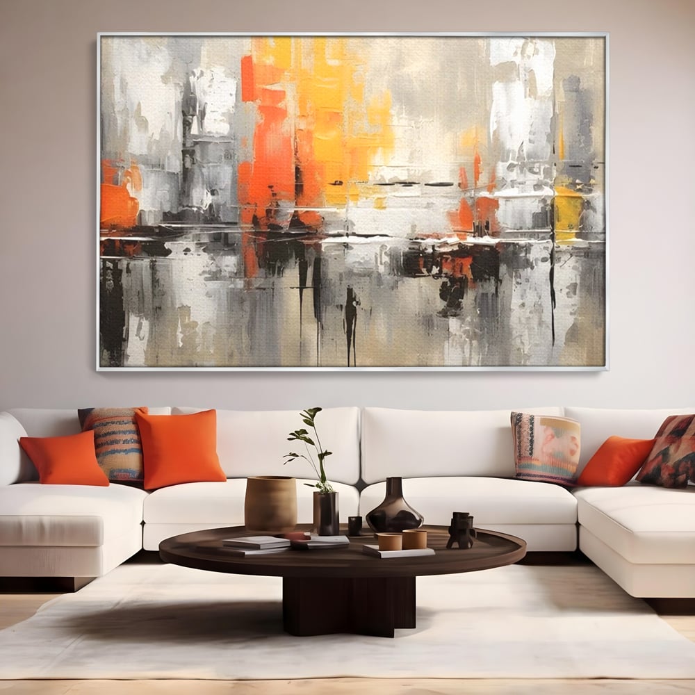 Tablou canvas cu pictura abstracta cu turnuri portocalii, in rama de aluminiu argintiu, pe perete intr-un living